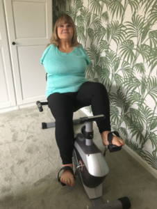 Activity Champion Mandy working out on her exercise bike at home