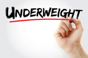 The word underweight with a red line being drawn underneath it by a hand