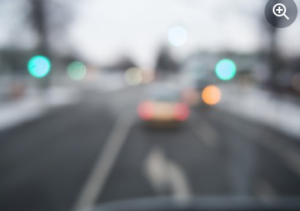 Blurred view of a car travelling away along a street