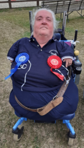 Lorraine Mercer wearing rosettes for competing in RDA driving events